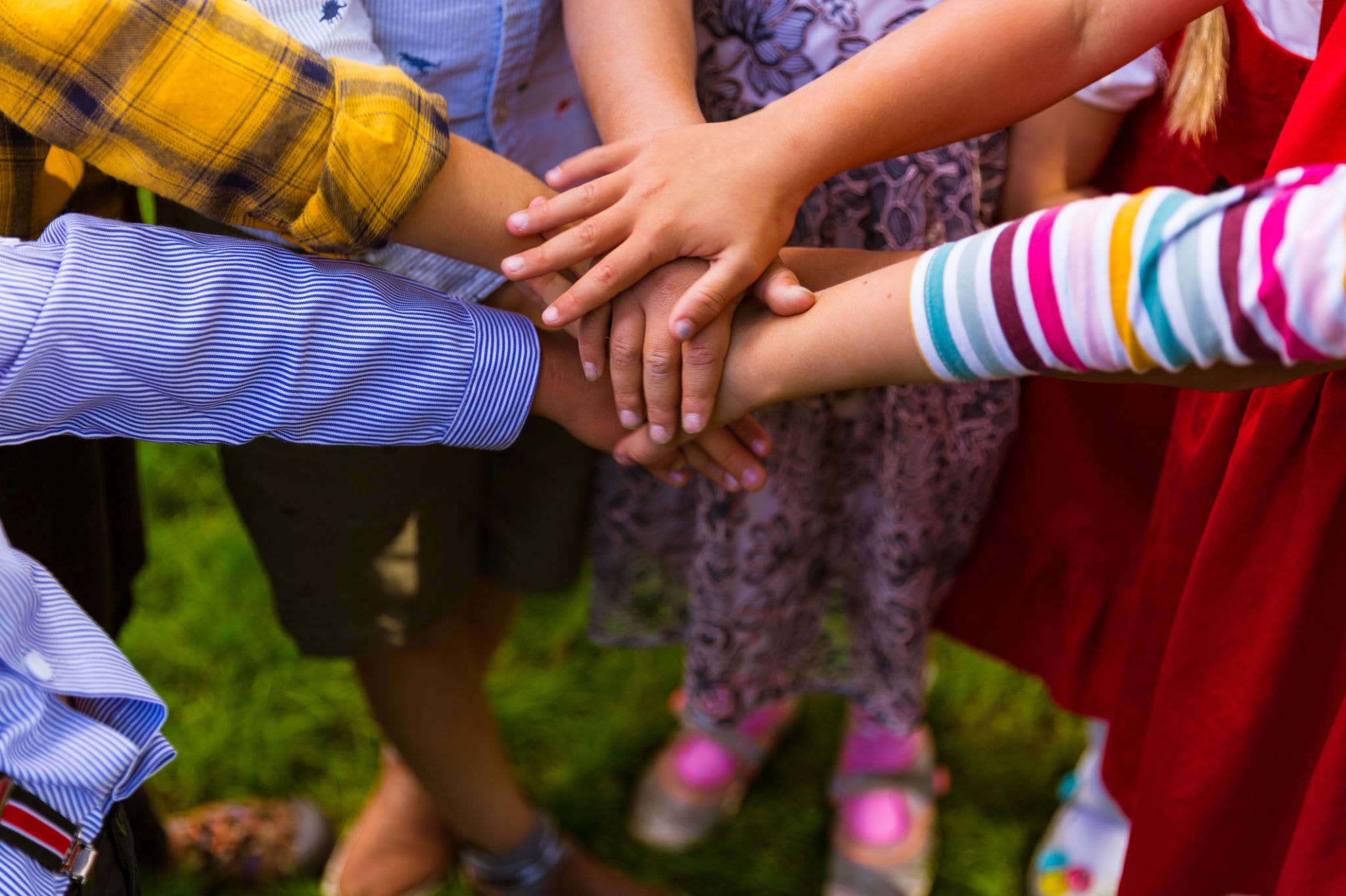 Children joining hands together in unity